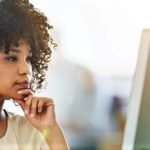 Woman looking at computer to find people online in South Africa